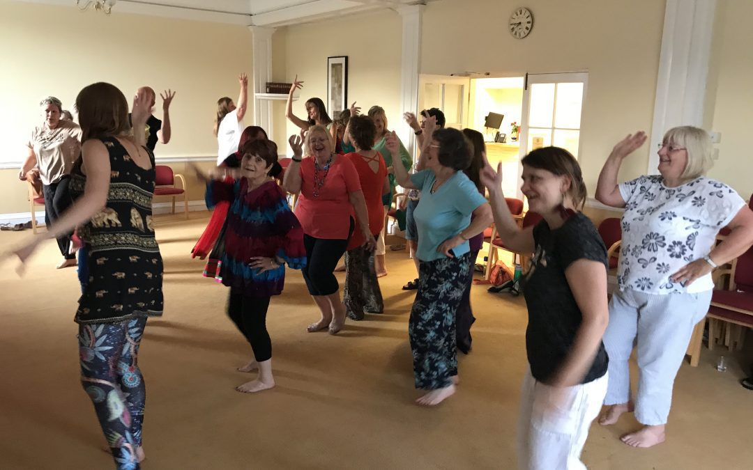 14 people laughing and dancing barefoot