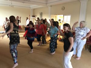 14 people laughing and dancing barefoot